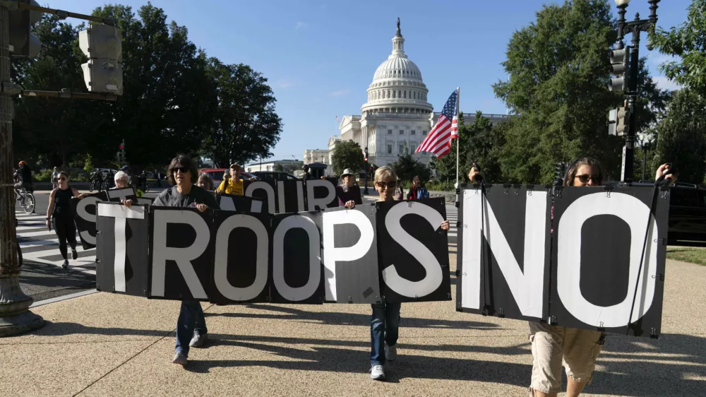 Demonstrators protest against President Donald Trump's use of federal law enforcement and National Guard troops in the city during protest at the U.S. Capitol, Tuesday, Sept. 2, 2025, in Washington. (AP Photo/Jose Luis Magana)