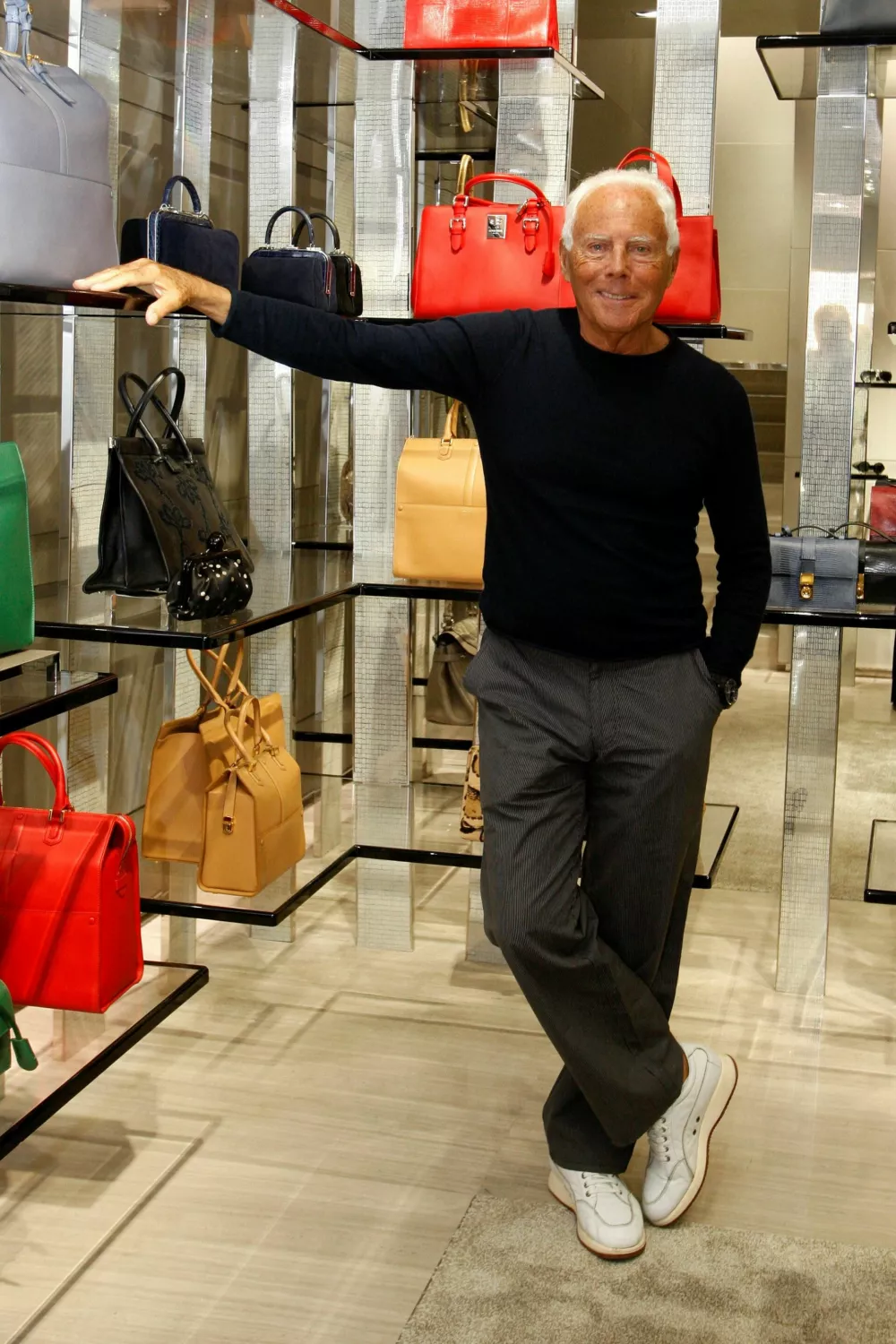 FILE PHOTO: Italian designer Giorgio Armani poses for pictures inside his boutique in Via Condotti, in Rome, Italy, June 5, 2013. REUTERS/Remo Casilli/File Photo
