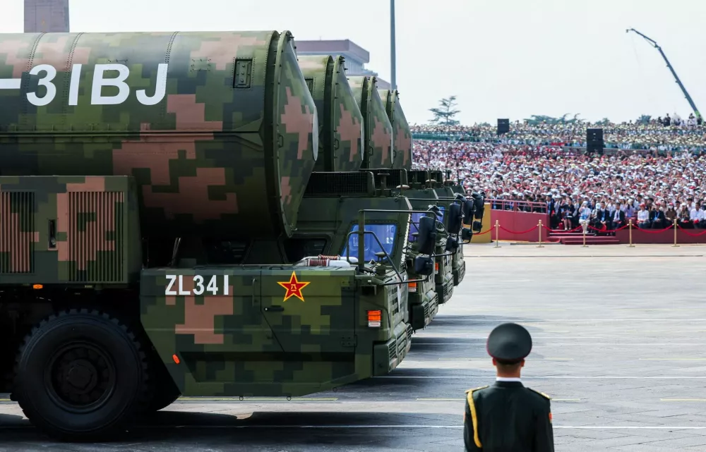 A member of the People's Liberation Army stands as the strategic strike group displays DF-31BJ nuclear missiles during a military parade to mark the 80th anniversary of the end of World War Two, in Beijing, China, September 3, 2025. REUTERS/Maxim Shemetov