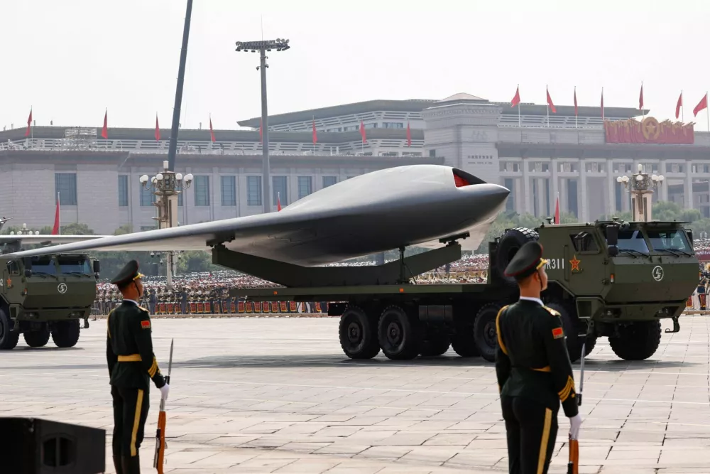 Members of the People's Liberation Army stand as unmanned operations group display a drone during a military parade to mark the 80th anniversary of the end of World War Two, in Beijing, China, September 3, 2025. REUTERS/Tingshu Wang