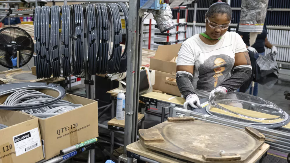 FILE - An employee pieces together components on an assembly line at GE Appliances global headquarters, Wednesday, Aug 13, 2025, in Louisville, Ky. (AP Photo/Jon Cherry, File)