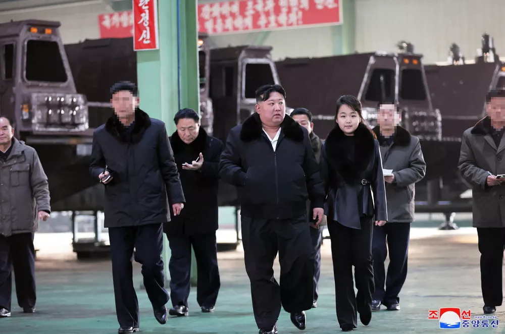 This undated picture released from North Korea's official Korean Central News Agency (KCNA) via KNS on January 5, 2024 shows North Korea's leader Kim Jong Un (C) inspecting an important military vehicle production plant with his daughter Ju Ae (R) at an undisclosed location in North Korea.,Image: 834308675, License: Rights-managed, Restrictions: South Korea OUT / REPUBLIC OF KOREA OUT - NOTE: FACES BLURRED FROM SOURCE---EDITORS NOTE--- RESTRICTED TO EDITORIAL USE - MANDATORY CREDIT "AFP PHOTO/KCNA VIA KNS" - NO MARKETING NO ADVERTISING CAMPAIGNS - DISTRIBUTED AS A SERVICE TO CLIENTS / THIS PICTURE WAS MADE AVAILABLE BY A THIRD PARTY. AFP CAN NOT INDEPENDENTLY VERIFY THE AUTHENTICITY, LOCATION, DATE AND CONTENT OF THIS IMAGE ---, ***HANDOUT image or SOCIAL MEDIA IMAGE or FILMSTILL for EDITORIAL USE ONLY! * Please note: Fees charged by Profimedia are for the Profimedia's services only, and do not, nor are they intended to, convey to the user any ownership of Copyright or License in the material. Profimedia does not claim any ownership including but not limited to Copyright or License in the attached material. By publishing this material you (the user) expressly agree to indemnify and to hold Profimedia and its directors, shareholders and employees harmless from any loss, claims, damages, demands, expenses (including legal fees), or any causes of action or allegation against Profimedia arising out of or connected in any way with publication of the material. Profimedia does not claim any copyright or license in the attached materials. Any downloading fees charged by Profimedia are for Profimedia's services only. * Handling Fee Only ***, Model Release: no