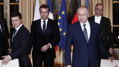 Russian President Vladimir Putin, right, Ukrainian President Volodymyr Zelenskiy, left, and French President Emmanuel Macron, center, arrive at a working session at the Elysee Palace Monday, Dec. 9, 2019 in Paris. Russian President Vladimir Putin and Ukraine's president are meeting for the first time at a summit in Paris to find a way to end the five years of fighting in eastern Ukraine. (Ian Langsdon/Pool via AP)