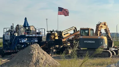An American flag flies above a piece of heavy machinery at the site of Hyundai Motor Group's electric vehicle plant in Ellabell, Georgia, Friday, Sept. 5, 2025. (AP Photo/Russ Bynum)