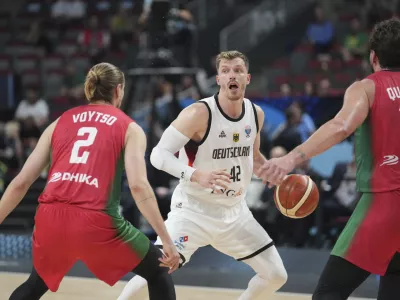 Germany's Andreas Obst, centre, in action during the Eurobasket, European Basketball Championship round of 16 match between Germany and Portugal at the Riga Arena in Riga, Latvia, Saturday, Sept. 6, 2025. (AP Photo/Sergei Grits)