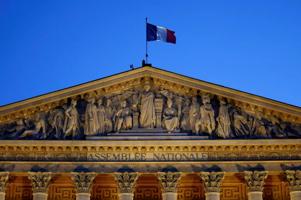 A French flag flutters on top of the National Assembly ahead of a confidence vote that the French Prime Minister Francois Bayrou seeks on the budget issue, in Paris, France, September 6, 2025. REUTERS/Abdul Saboor   TPX IMAGES OF THE DAY