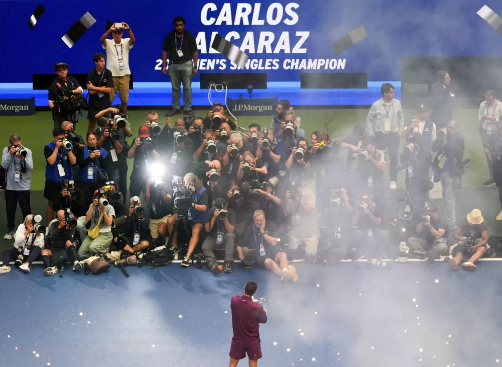 Carlos Alcaraz, of Spain, holds the championship trophy after defeating Jannik Sinner, of Italy, in the men's singles final of the U.S. Open tennis championships, Sunday, Sept. 7, 2025, in New York. (AP Photo/Yuki Iwamura)