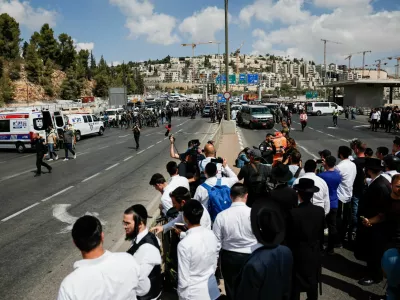 People gather near the scene where a suspected shooting attack took place at the outskirts of Jerusalem, September 8, 2025 REUTERS/Ammar Awad