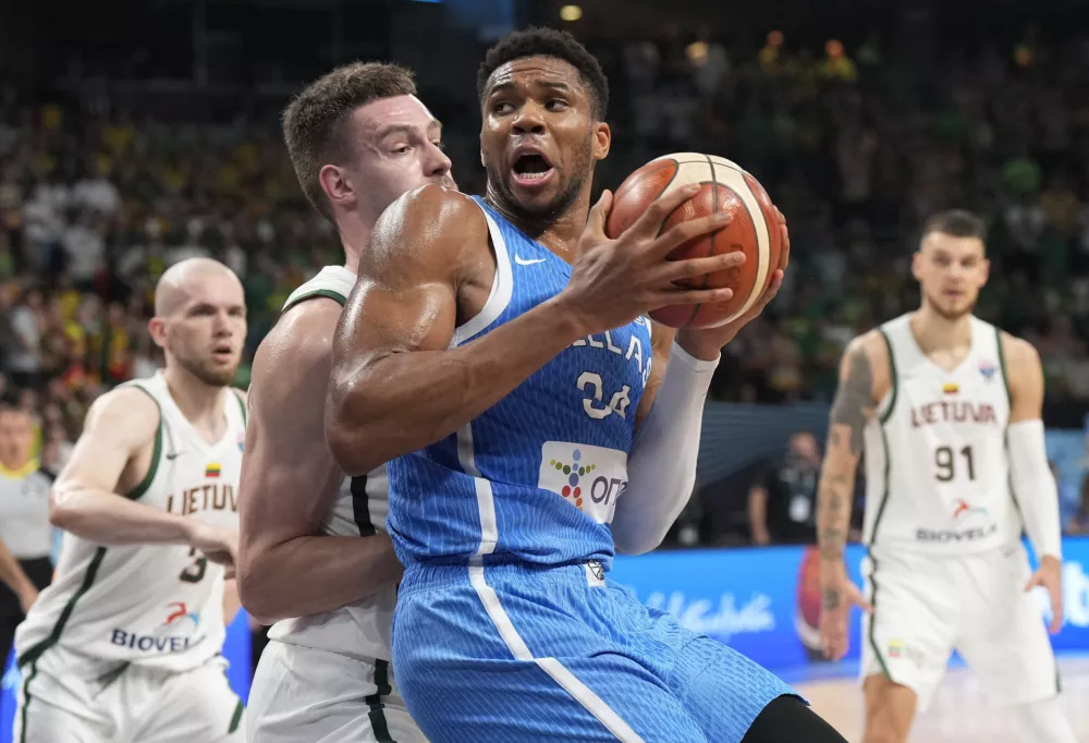 Basketball - FIBA EuroBasket 2025 - Quarter Finals - Lithuania v Greece - Xiaomi Arena, Riga, Latvia - September 9, 2025 Greece's Giannis Antetokounmpo in action with Lithuania's Marek Blazevic REUTERS/Ints Kalnins