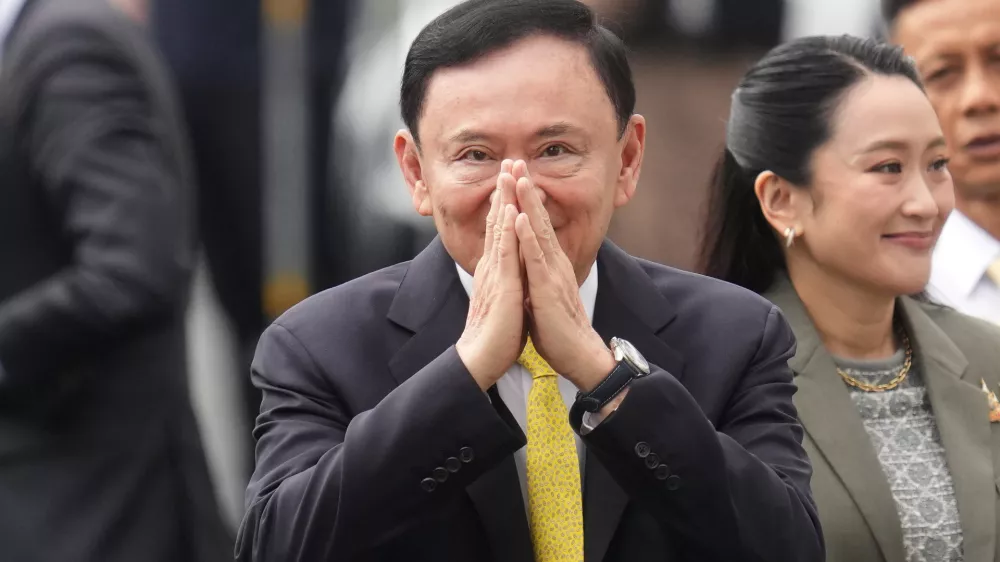 Thailand's former Prime Minister Thaksin Shinawatra, center, and his daughter and former Prime Minister Pinthongta Shinawatra, right, arrive at Supreme Court in Bangkok, Thailand, Tuesday, Sept. 9, 2025. (AP Photo/Sakchai Lalit)