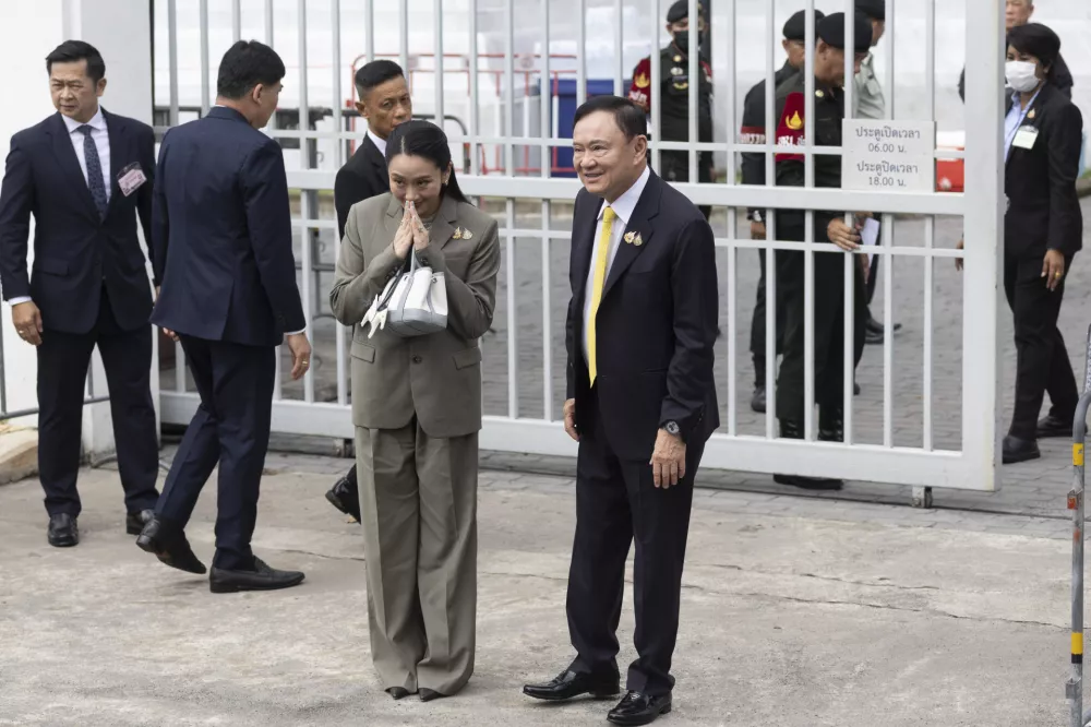 Thailand's former Prime Minister Thaksin Shinawatra, center right, and his daughter and former Prime Minister Pinthongta Shinawatra, center left, arrive at Supreme Court in Bangkok, Thailand, Tuesday, Sept. 9, 2025.(AP Photo/Wason Wanitchakorn)