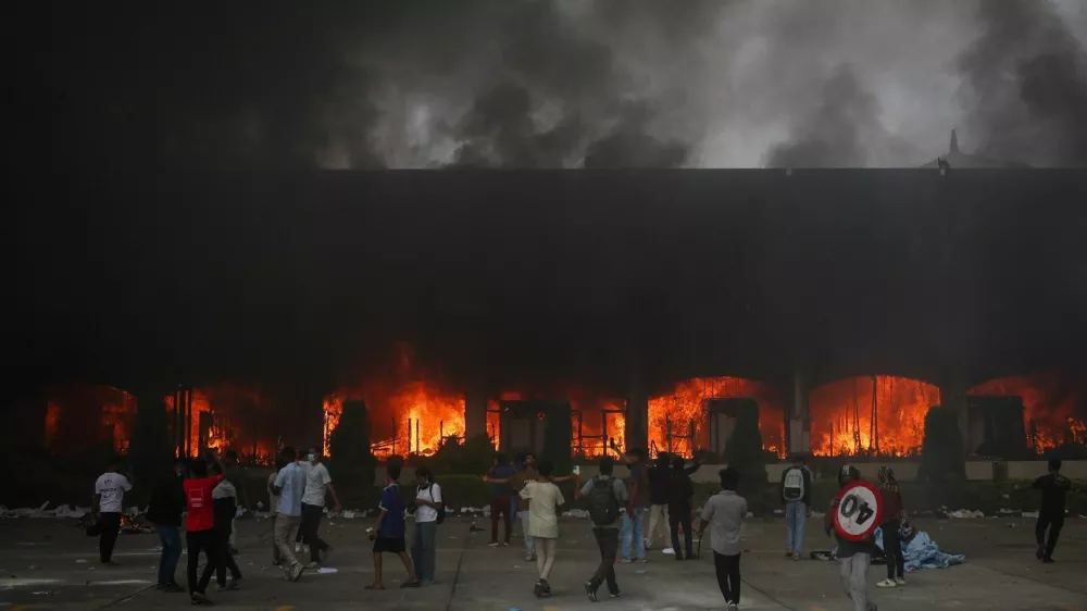A fire burns inside the Parliament complex during a protest against Monday's killing of 19 people after anti-corruption protests that were triggered by a social media ban, which was later lifted, during a curfew in Kathmandu, Nepal, September 9, 2025. REUTERS/Adnan Abidi