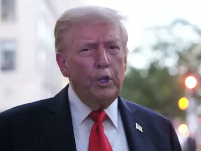 President Donald Trump speaks to reporters before he enters a restaurant near the White House, Tuesday, Sept. 9, 2025, in Washington, to have dinner. (AP Photo/Alex Brandon)