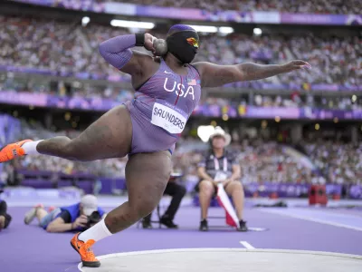 Raven Saunders, of the United States, competes during the women's shot put qualification at the 2024 Summer Olympics, Thursday, Aug. 8, 2024, in Saint-Denis, France. (AP Photo/Bernat Armangue)
