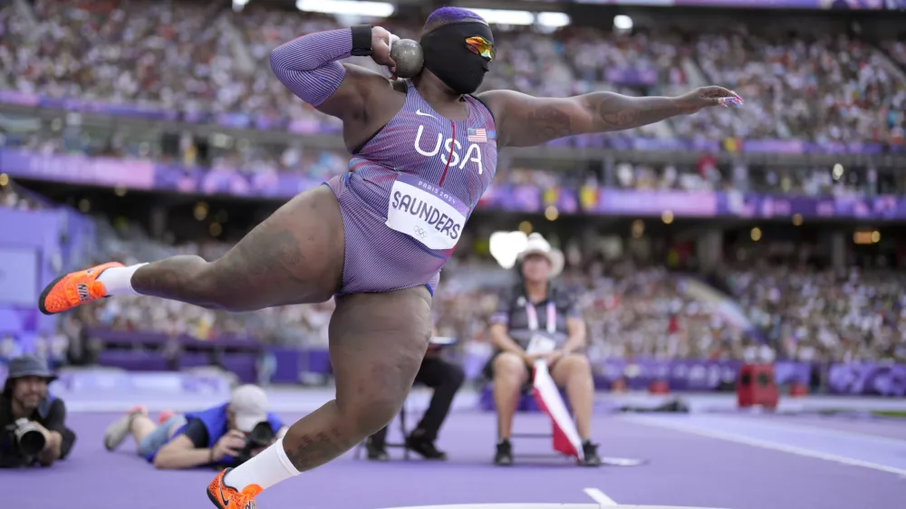 Raven Saunders, of the United States, competes during the women's shot put qualification at the 2024 Summer Olympics, Thursday, Aug. 8, 2024, in Saint-Denis, France. (AP Photo/Bernat Armangue)
