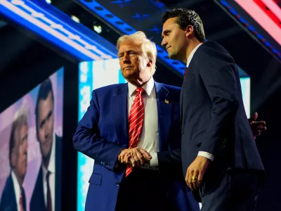 FILE PHOTO: U.S. President-elect Donald Trump shakes hands with Turning Point USA founder Charlie Kirk, at Turning Point USA's AmericaFest in Phoenix, Arizona, U.S., December 22, 2024. REUTERS/Cheney Orr/File Photo