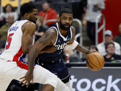 Jan 31, 2025; Detroit, Michigan, USA; Dallas Mavericks guard Kyrie Irving (11) is defended by Detroit Pistons guard Malik Beasley (5) in the first half at Little Caesars Arena. Mandatory Credit: Rick Osentoski-Imagn Images