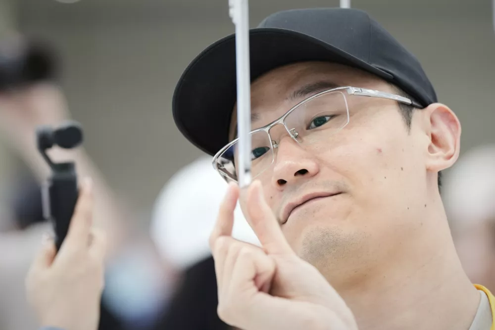 An attendee takes a closer look at the iPhone Air during an announcement of new products at Apple Park on Tuesday, Sept. 9, 2025, in Cupertino, Calif. (AP Photo/Godofredo A. V&aacute;squez)