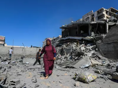 Palestinians inspect the site of an evacuated residential building, which was housing displaced Palestinians, after it was hit by an Israeli air strike, in Gaza City, September 12, 2025. REUTERS/Ebrahim Hajjaj