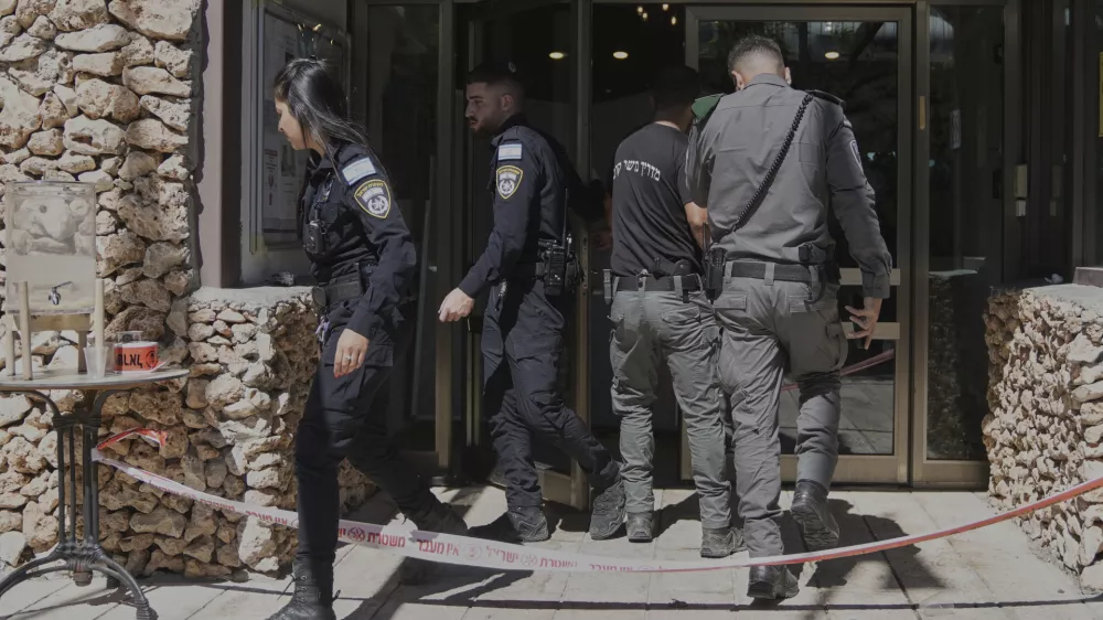 Members of the Israeli security forces work at the scene of a stabbing attack at a hotel in the Kibbutz Tzova, outside Jerusalem, Friday, Sept. 12, 2025. (AP Photo/Mahmoud Illean)