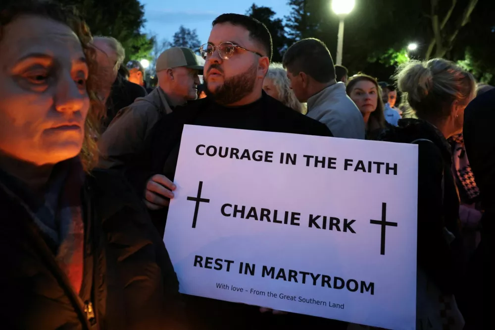 People gather during a vigil for U.S. right-wing activist and commentator Charlie Kirk, who was fatally shot while speaking at an outdoor event at Utah Valley University in the U.S., in Sydney, Australia, September 12, 2025. REUTERS/Hollie Adams