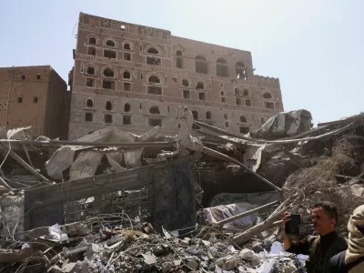 A member of the media uses a mobile phone to film at the site of Wednesday's Israeli airstrikes, in Sanaa, Yemen September 14, 2025. REUTERS/Khaled Abdullah