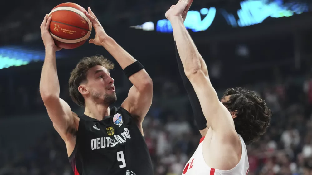 Germany's Franz Wagner, left,&nbsp;tries to score as&nbsp;Turkey's Cedi Osman blocks him during the Eurobasket, European Basketball Championship final match between Turkey and Germany at the Riga Arena in Riga, Latvia, Sunday, Sept. 14, 2025. (AP Photo/Sergei Grits)