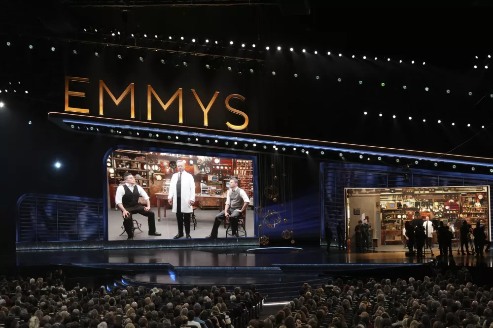 Bowen Yang, from left, Host Nate Bargatze, and Mikey Day during the 77th Primetime Emmy Awards on Sunday, Sept. 14, 2025, at the Peacock Theater in Los Angeles. (AP Photo/Chris Pizzello)