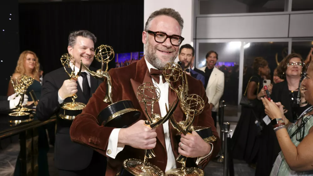 IMAGE DISTRIBUTED FOR THE TELEVISION ACADEMY &ndash; EXCLUSIVE - Seth Rogen picks up their official Emmy statuette at the 77th Emmy Awards Trophy Table on Sunday, Sept. 14, 2025 at the Peacock Theater in Los Angeles. (Photo by Mark Von Holden/Invision for the Television Academy/AP Content Services)