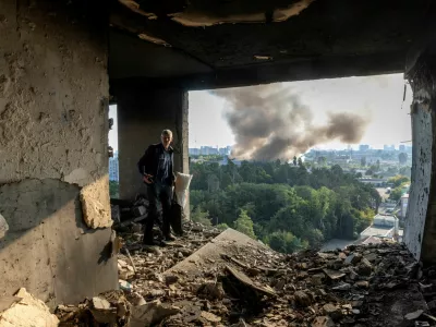 A friend of the owner inspects the damage in an apartment that was hit during a Russian drone strike, amid Russia's attack on Ukraine, in Kyiv, Ukraine September 7, 2025. REUTERS/Thomas Peter    TPX IMAGES OF THE DAY