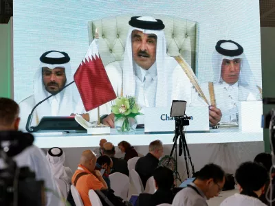 Journalists watch on a screen at the media center as Sheikh Tamim bin Hamad Al Thani, the emir of Qatar, speaks during the opening of the emergency Arab-Islamic summit, to discuss the Israeli attack on Hamas on the Gulf country's soil, in Doha, Qatar, September 15, 2025. REUTERS/Ibraheem Abu Mustafa