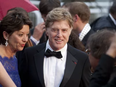 Actor Robert Redford, centre, and his wife Sibylle Szaggars, centre left, arrive for the screening of All Is Lost at the 66th international film festival, in Cannes, southern France, Wednesday, May 22, 2013. (AP Photo/Virginia Mayo)