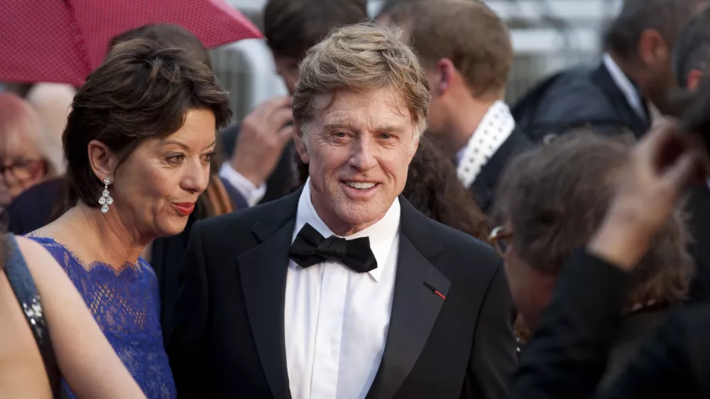 Actor Robert Redford, centre, and his wife Sibylle Szaggars, centre left, arrive for the screening of All Is Lost at the 66th international film festival, in Cannes, southern France, Wednesday, May 22, 2013. (AP Photo/Virginia Mayo)