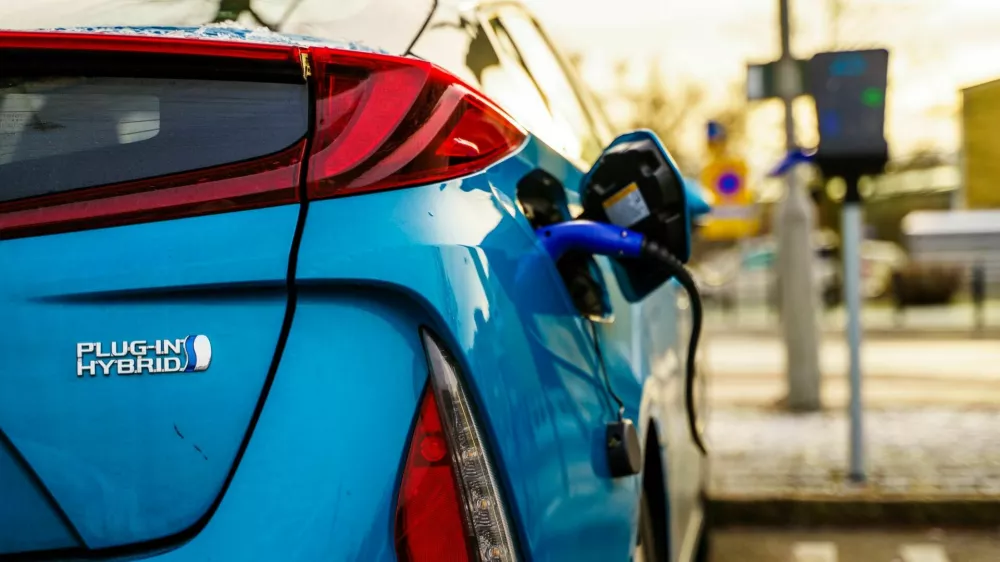 Gothenburg, Sweden - December 1, 2019: Electric plug in hybrid car parked on street parking lot for charging