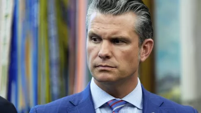 Defense Secretary Pete Hegseth listens as President Donald Trump speaks in the Oval Office of the White House, Monday, Sept. 15, 2025, in Washington. (AP Photo/Alex Brandon)