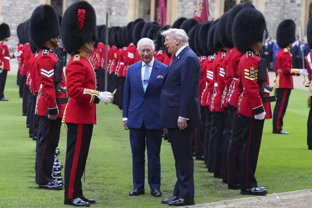 President Donald Trump and Britain's King Charles III review the Guard of Honour after the arrival at Windsor Castle in Windsor, England, Wednesday, Sept. 17, 2025.(AP Photo/Kirsty Wigglesworth, Pool)