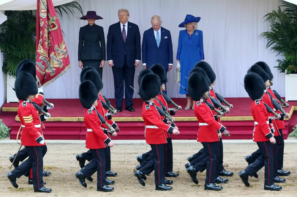 First Lady Melania Trump, U.S. President Donald Trump, King Charles III and Queen Camilla inspect the guard of honor during the State visit by the President of the United States of America at Windsor Castle on September 17, 2025 in Windsor, England.   Chris Jackson/Pool via REUTERS