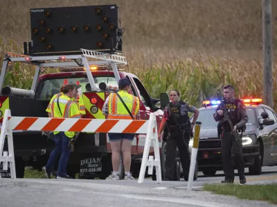 Pennsylvania state police troopers and emergency workers block a road after multiple police officers were shot and killed on Wednesday, Sept. 17, 2025, in North Codorus, Pa. (AP Photo/Matt Slocum)