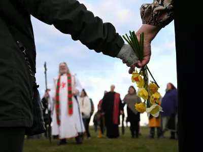 A reveller holds flowers as they attend spring equinox celebrations at Stonehenge stone circle, near Amesbury, Britain, March 20, 2025. REUTERS/Jaimi Joy
