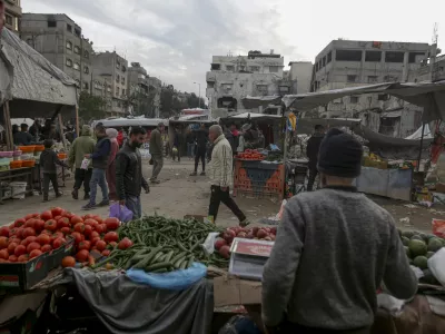 Palestinians shop at Sheikh Radwan Market, west of Gaza City, before the Iftar, the fast-breaking meal, during the holy month of Ramadan on Monday, March 3, 2025. (AP Photo/Jehad Alshrafi)