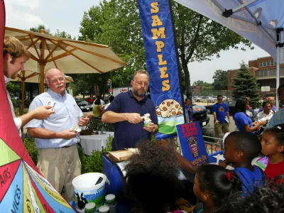 Ben Cohen, second from left, and Jerry Greenfield, center, founders of Ben & Jerry Homemade Inc., serve ice cream to Washington residents July 12, 2006, to kick off a federal budgets priority campaign. (AP Photo/Nick Wass)
