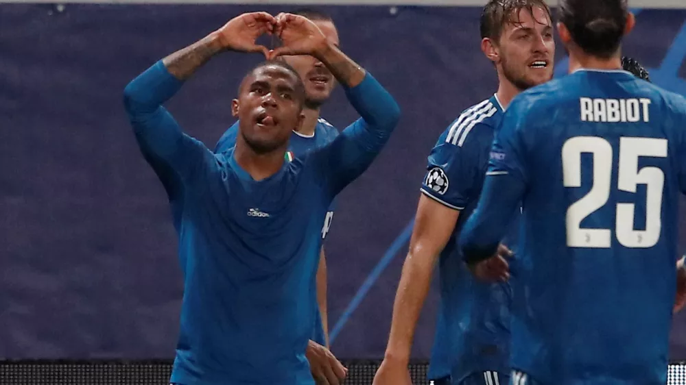 Soccer Football - Champions League - Group D - Lokomotiv Moscow v Juventus - RZD Arena, Moscow, Russia - November 6, 2019 Juventus' Douglas Costa celebrates scoring their second goal  REUTERS/Maxim Shemetov