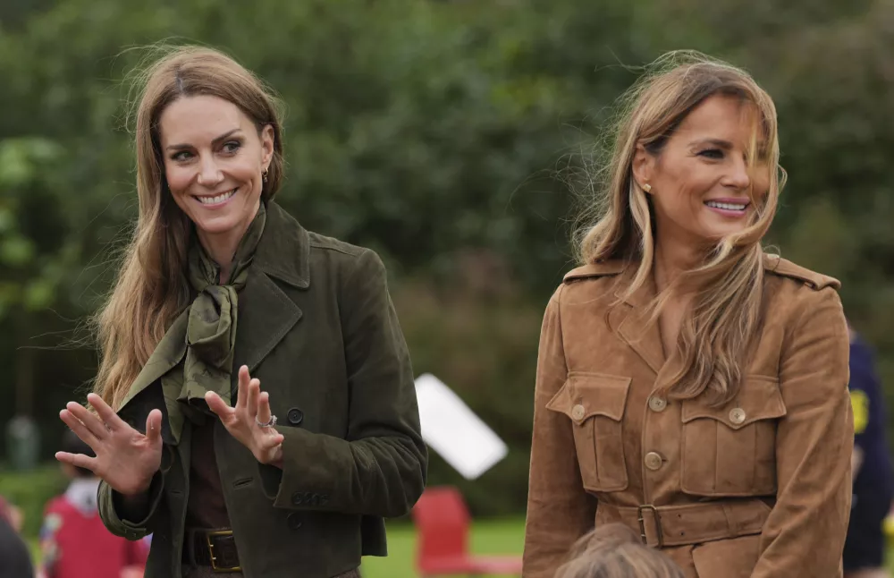 Britain's Kate, Princess of Wales, left, and first lady Melania Trump meet members of the Scouts' Squirrels programme in Frogmore Gardens, Windsor, England, Thursday, Sept. 18, 2025. (Yui Mok/Pool Photo via AP)