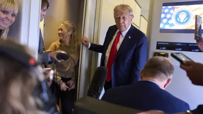 President Donald Trump speaks with reporters after departing the United Kingdom, Thursday, Sept. 18, 2025, aboard Air Force One. (AP Photo/Evan Vucci)