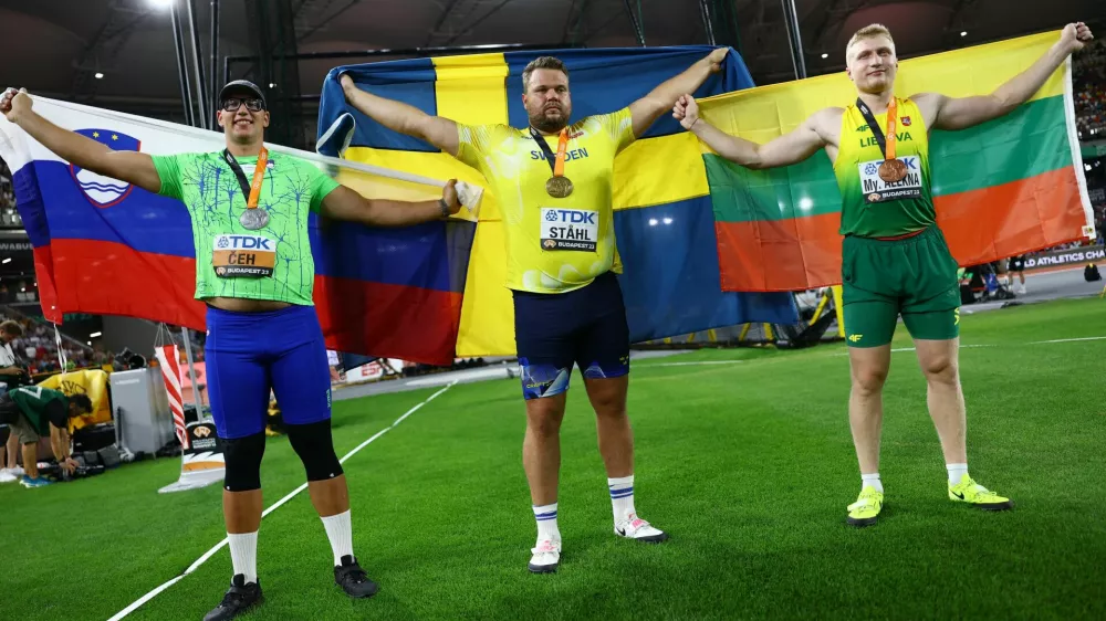 Athletics - World Athletics Championship - Men's Discus Throw Final - National Athletics Centre, Budapest, Hungary - August 21, 2023 Sweden's Daniel Stahl celebrates with the gold medal after winning the Men's Discus Throw alongside silver medalist Slovenia's Kristjan Ceh and bronze medalist Lithuania's Mykolas Alekna REUTERS/Kai Pfaffenbach