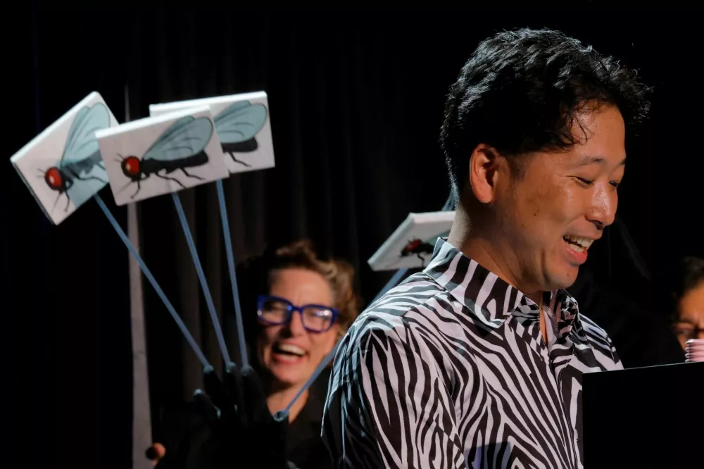Researcher Tomoki Kojima of Japan accepts the Ig Nobel Prize for Biology, on behalf of the research group for their study "Cows Painted with Zebra-like Striping Can Avoid Biting Fly Attack", during the 35th First Annual Ig Nobel Prize ceremony, in Boston, Massachusetts, U.S., September 18, 2025. REUTERS/Brian Snyder