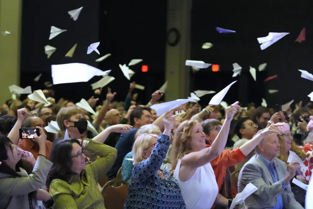 Audience members toss paper airplanes during the Ig Nobel Prize award ceremony, Thursday, Sept. 18, 2025, in Boston. (AP Photo/Robert F. Bukaty)
