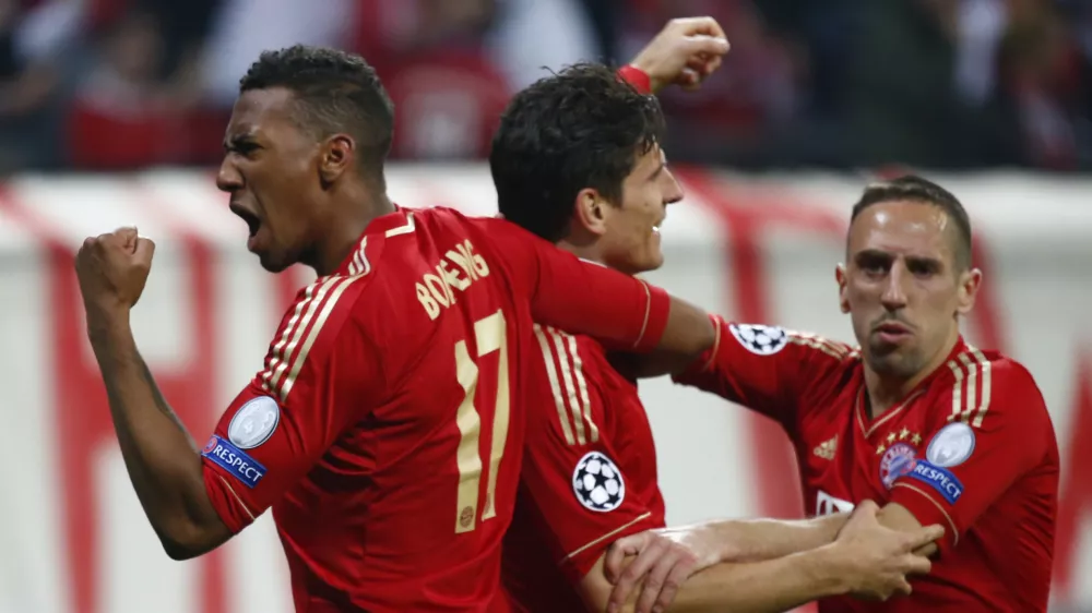 Bayern Munich's Mario Gomez celebrates with his team mates Franck Ribery (R) and Jerome Boateng (L) after scoring a goal against Barcelona during the Champions League semi-final first leg soccer match at Arena stadium in Munich April 23, 2013.         REUTERS/Michaela Rehle (GERMANY - Tags: SPORT SOCCER)