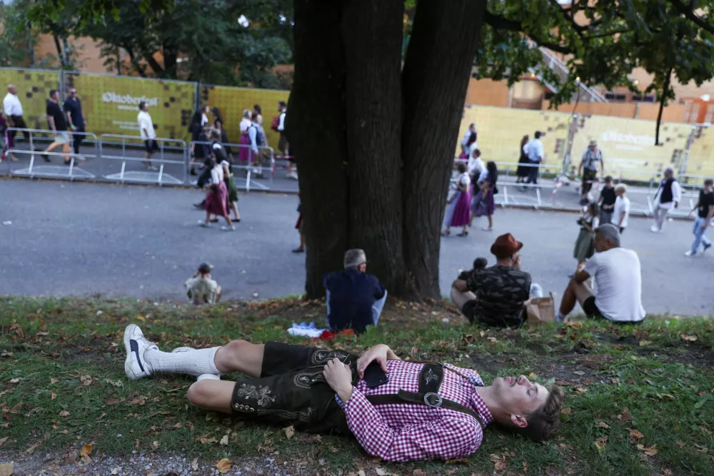 A man lies on the ground on the day of the official opening of the 190th Oktoberfest, the world's largest beer festival in Munich, Germany, September 20, 2025. REUTERS/Maryam Majd