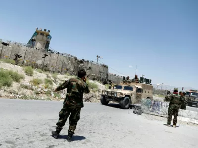 FILE PHOTO: Afghan soldiers stand guard at a checkpoint outside the U.S Bagram air base, on the day the last of American troops vacated it, Parwan province, Afghanistan July 2, 2021.REUTERS/Mohammad Ismail/File Photo